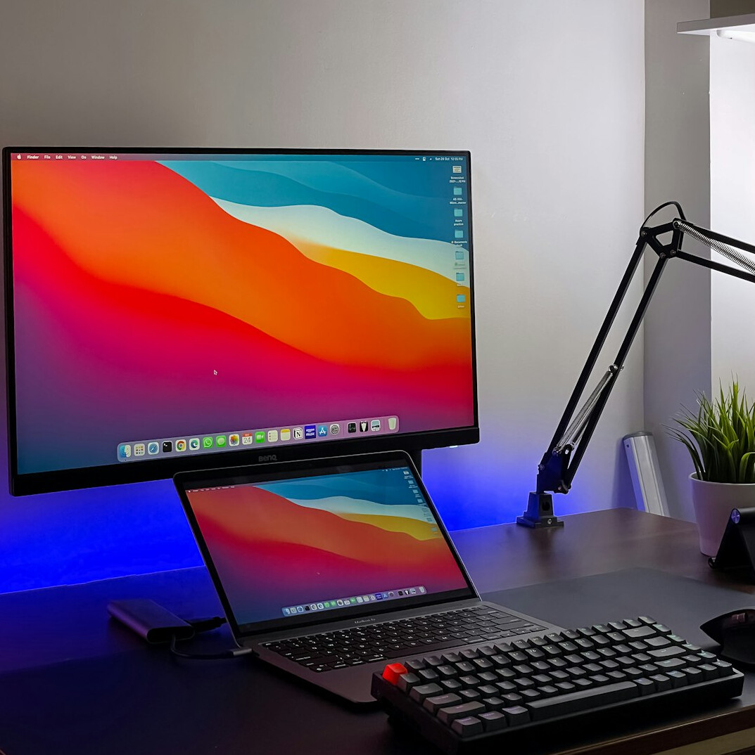 Laptop screen showing colorful data dashboards and charts on a desk